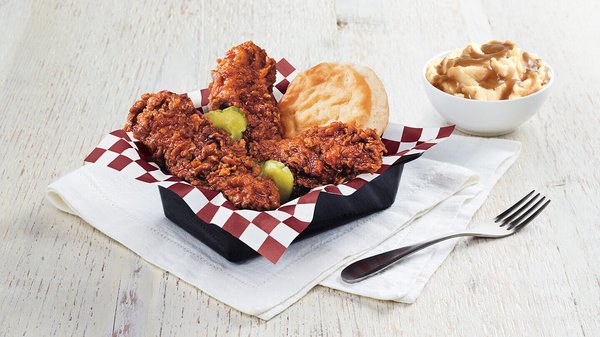 A KFC meal with chicken strips, mashed potatoes and a biscuit.