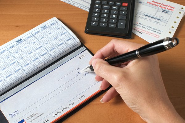 Hand writing on a blank check.