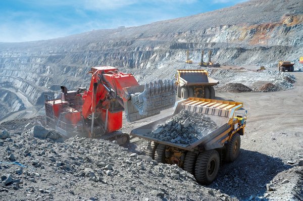 A truck picking up iron ore at a mine.