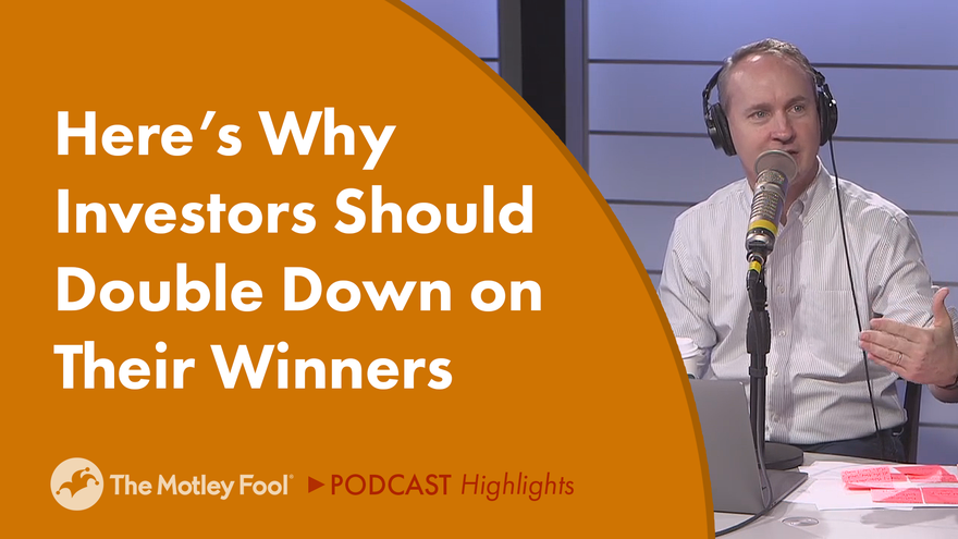 Older bald man wearing headphones speaks into a microphone
